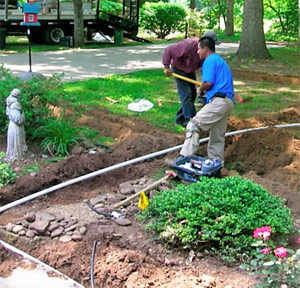 two of our pros are installing a new irrigation system